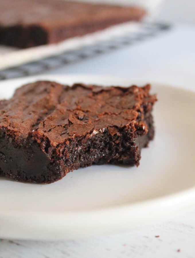 piece of flourless chocolate brownie on a plate.
