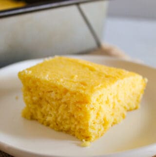 slice of gluten free cornbread on a white plate.