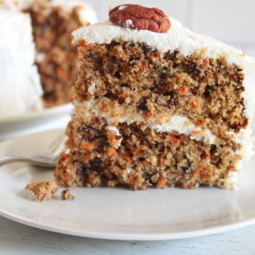 slice of gluten free carrot cake on a white plate.