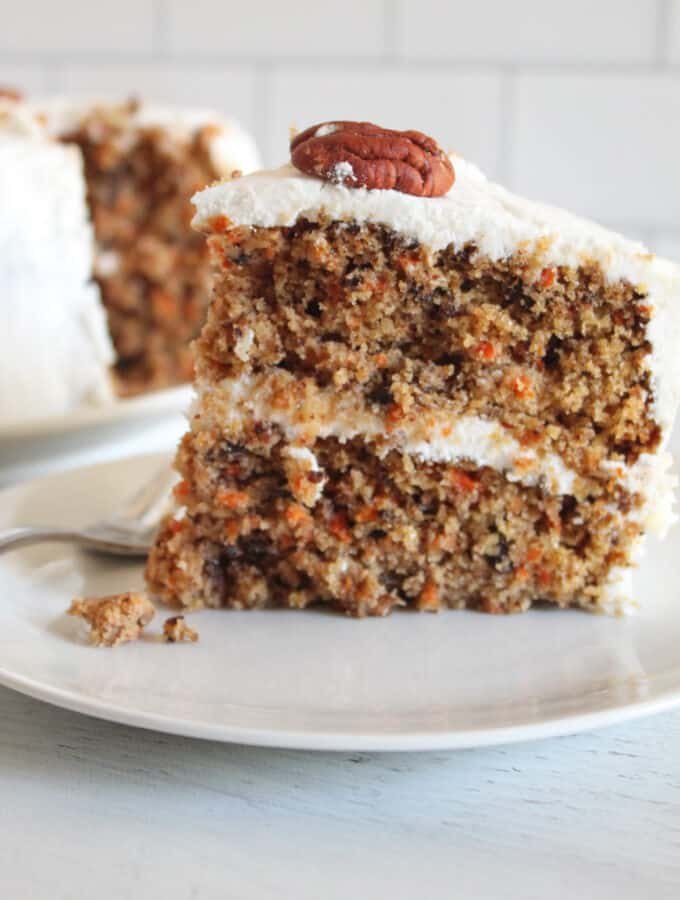 slice of gluten free carrot cake on a white plate.