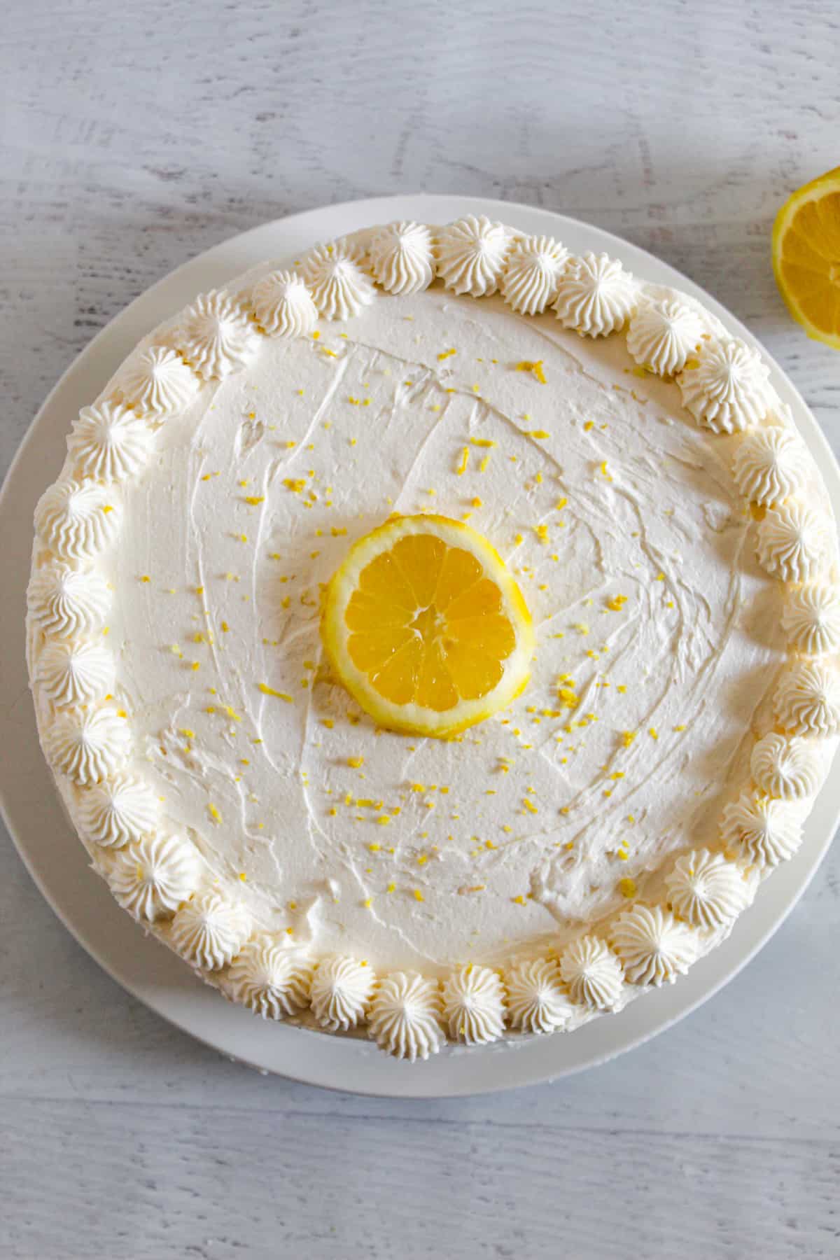 overhead shot of a whole frosted gluten free lemon cake.