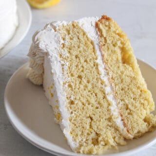 slice of gluten free lemon cake on a white plate.