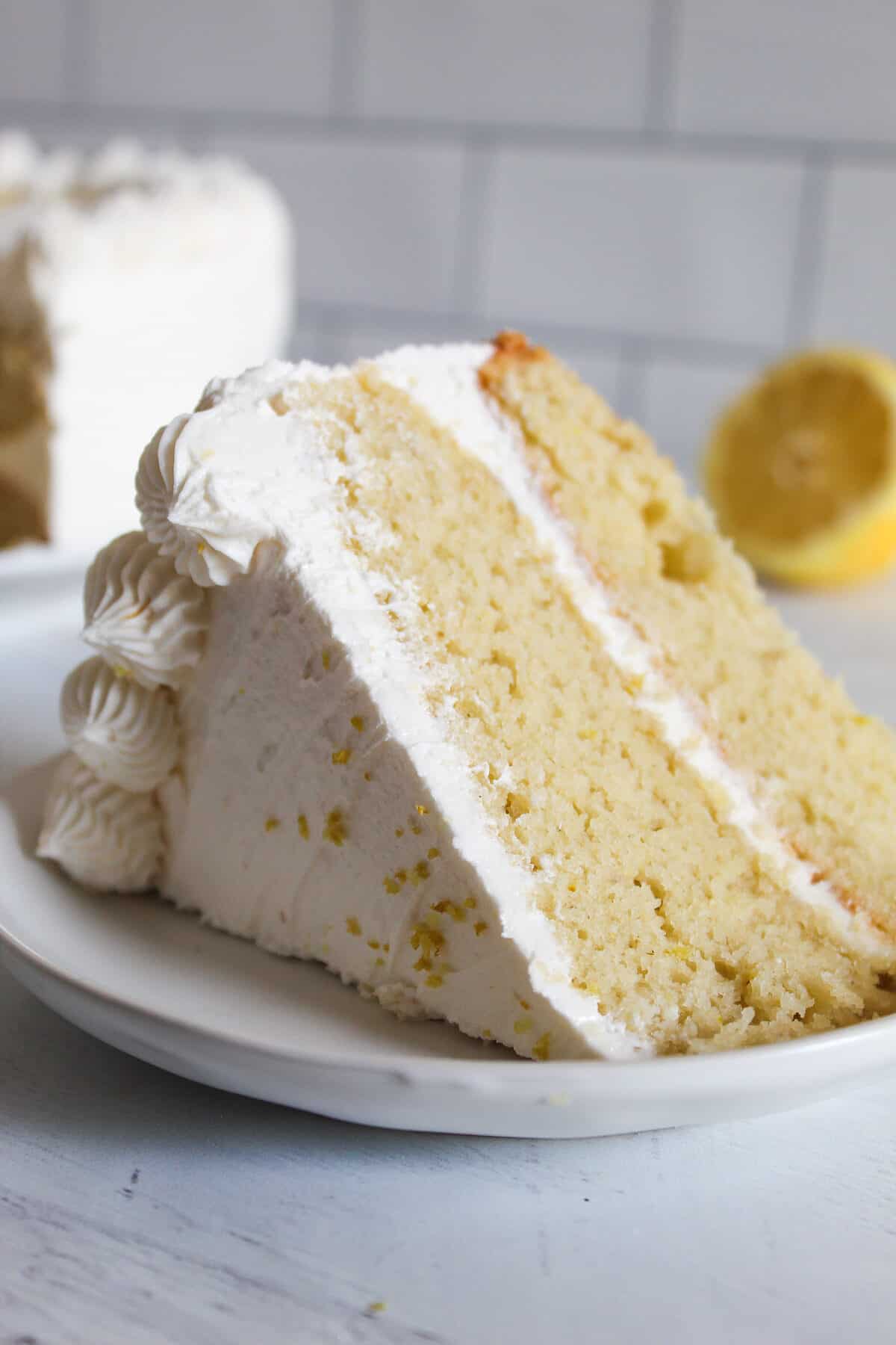 slice of gluten free lemon cake on a white plate.