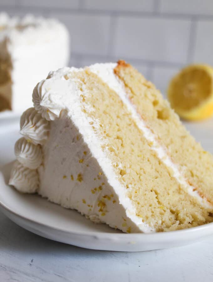 slice of gluten free lemon cake on a white plate.