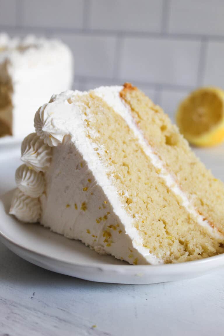 slice of gluten free lemon cake on a white plate.