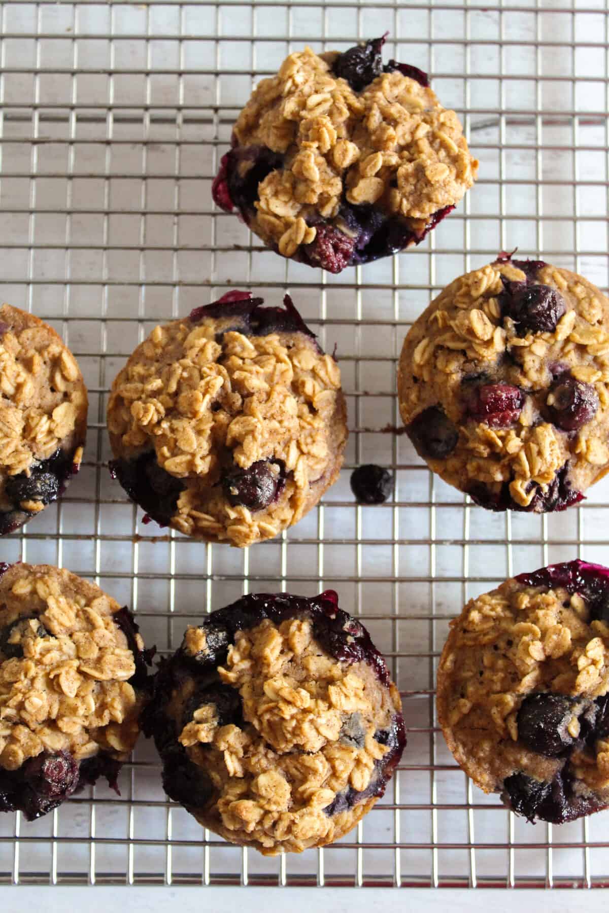 oatmeal blueberry muffins on a wire rack.