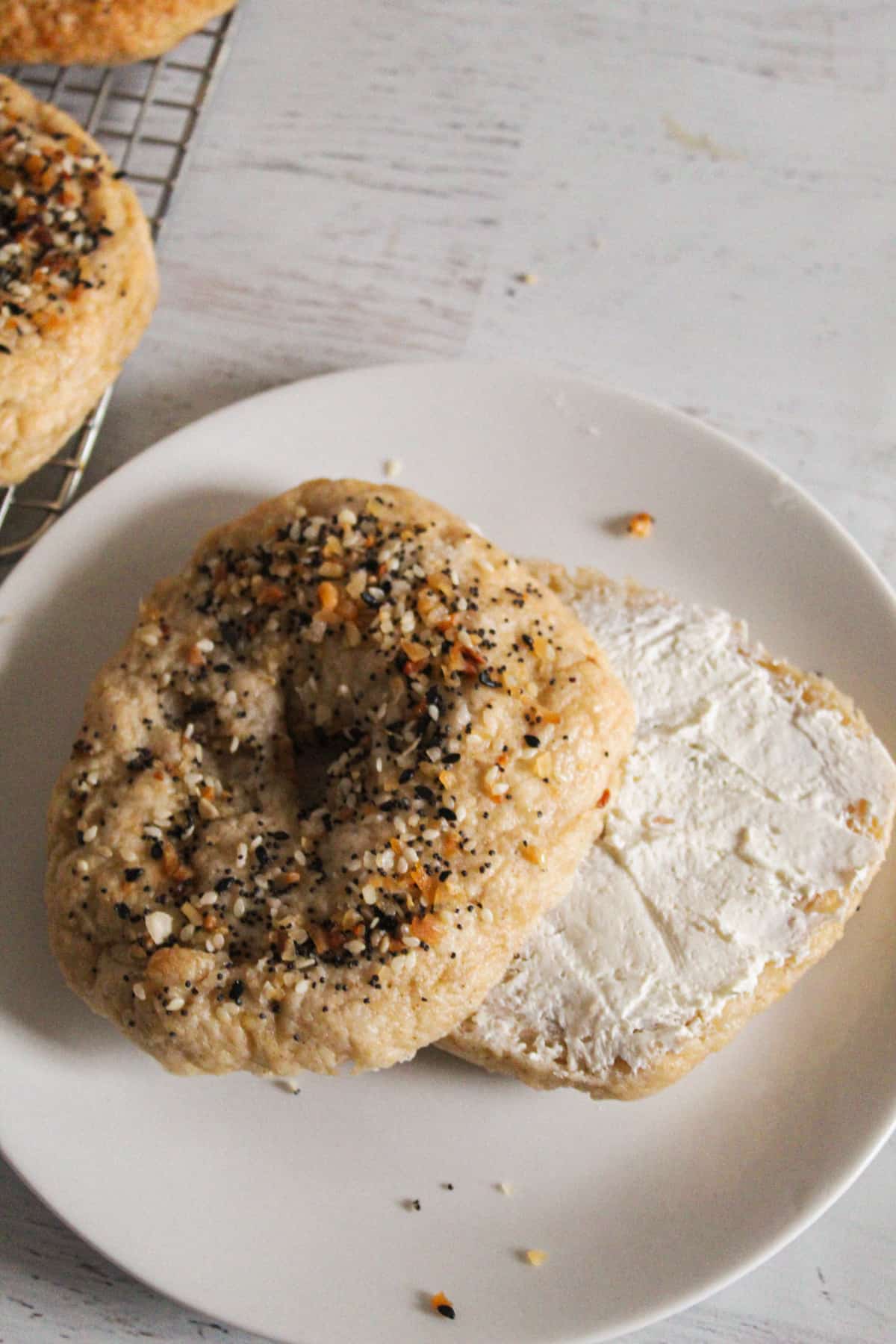sliced bagel with cream cheese on it.