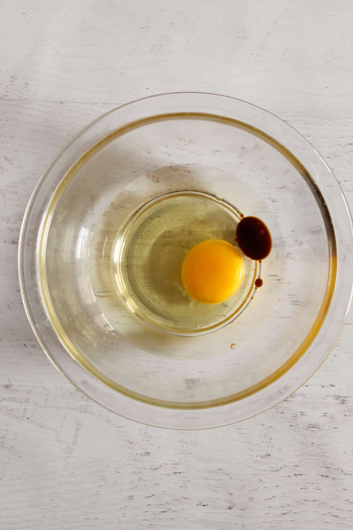 egg and oil in a glass bowl.