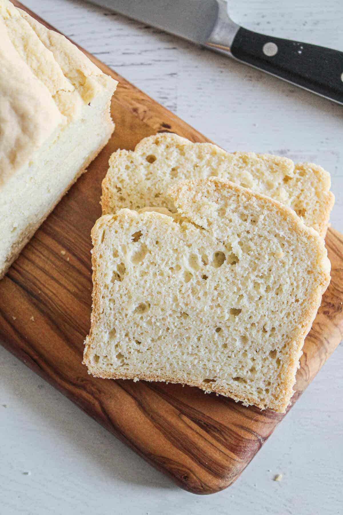 slices of gluten free yeast free bread on a cutting board.