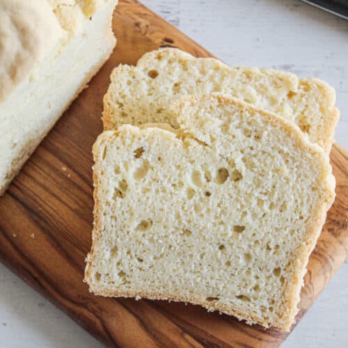 slices of gluten free yeast free bread on a cutting board.