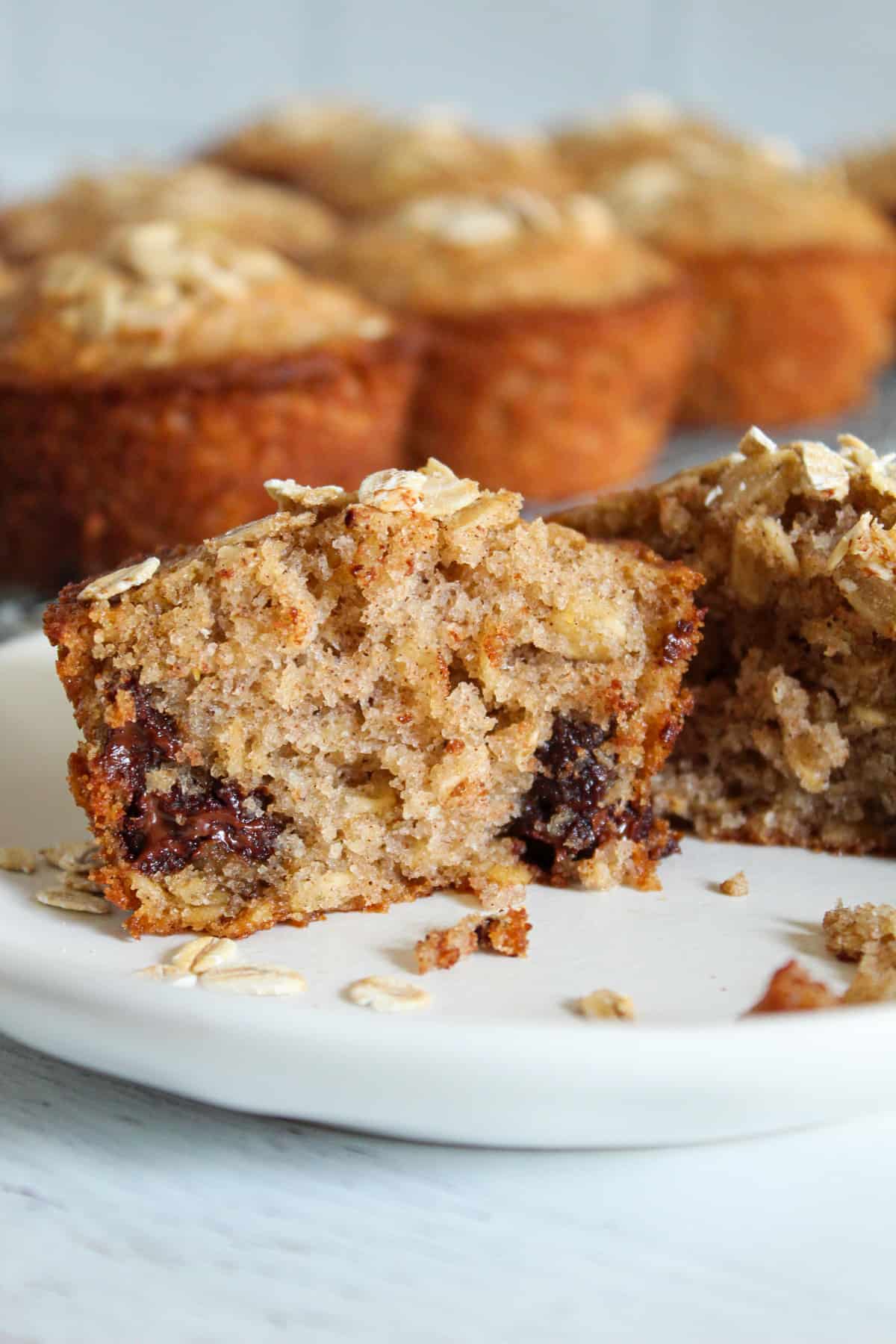 inside of an oatmeal chocolate chip muffin on a plate.