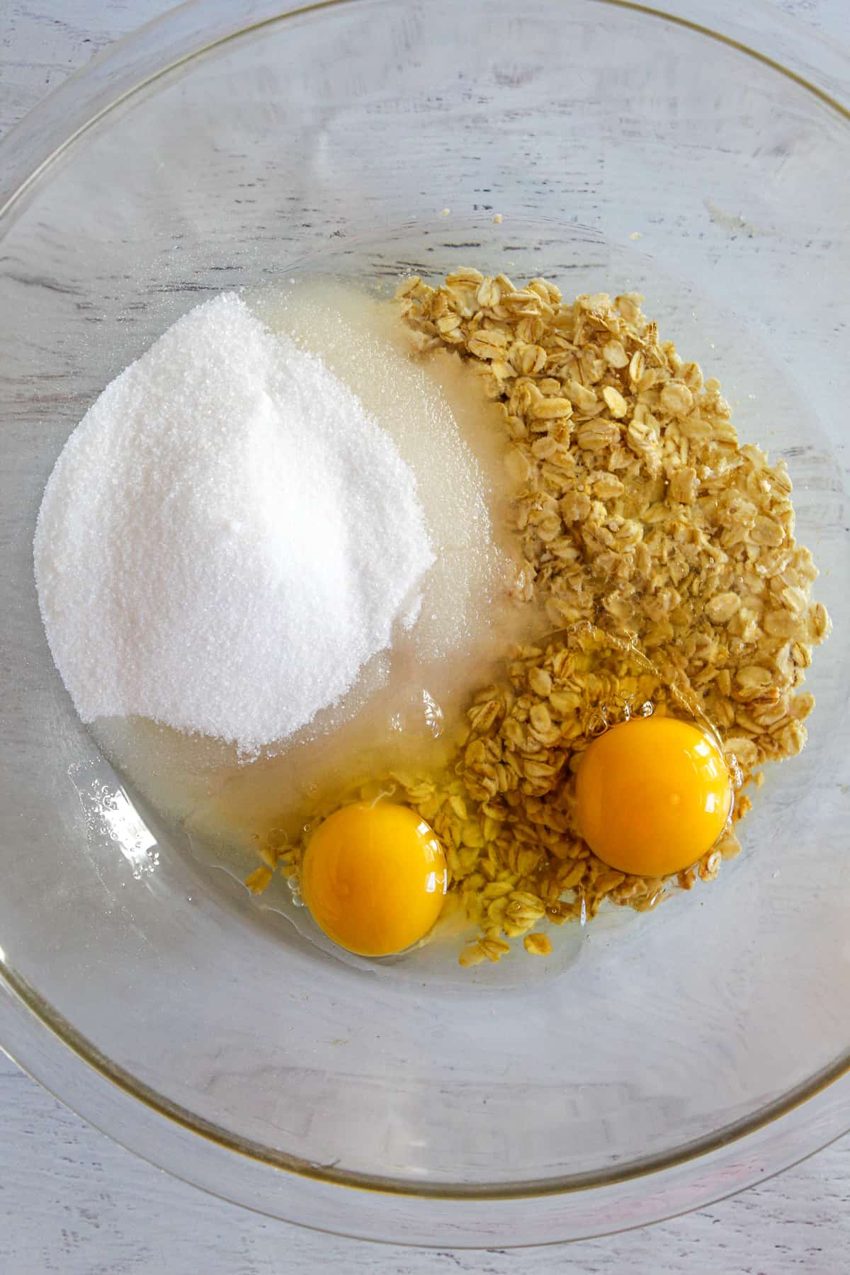 adding sugar to eggs in a bowl.