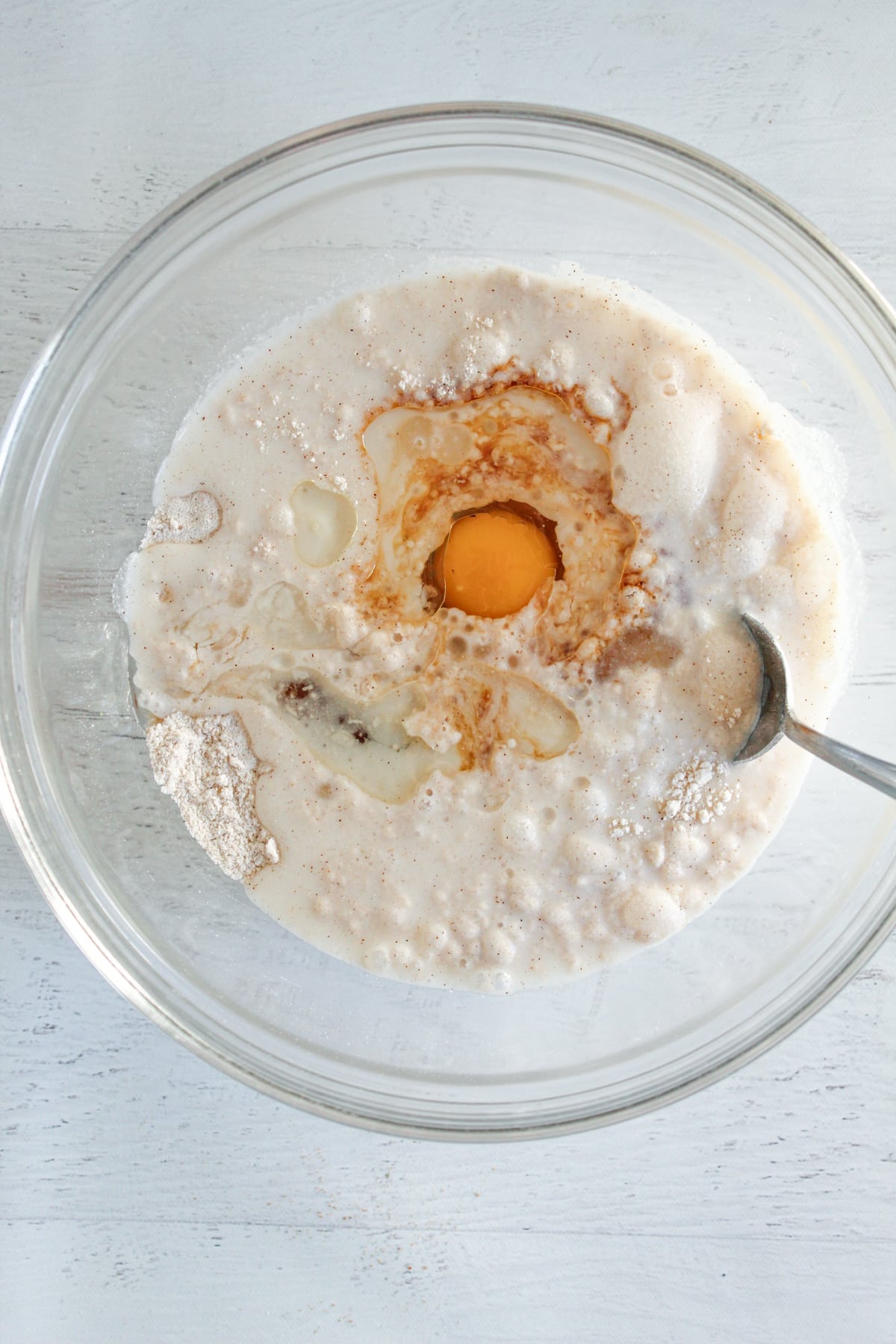 adding wet ingredients to a bowl of dry ingredients.