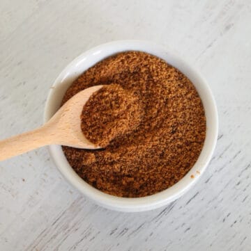white bowl of coconut sugar with a spoon.