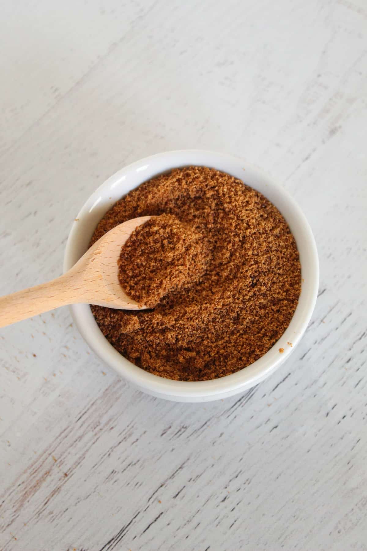 white bowl of coconut sugar with a spoon.