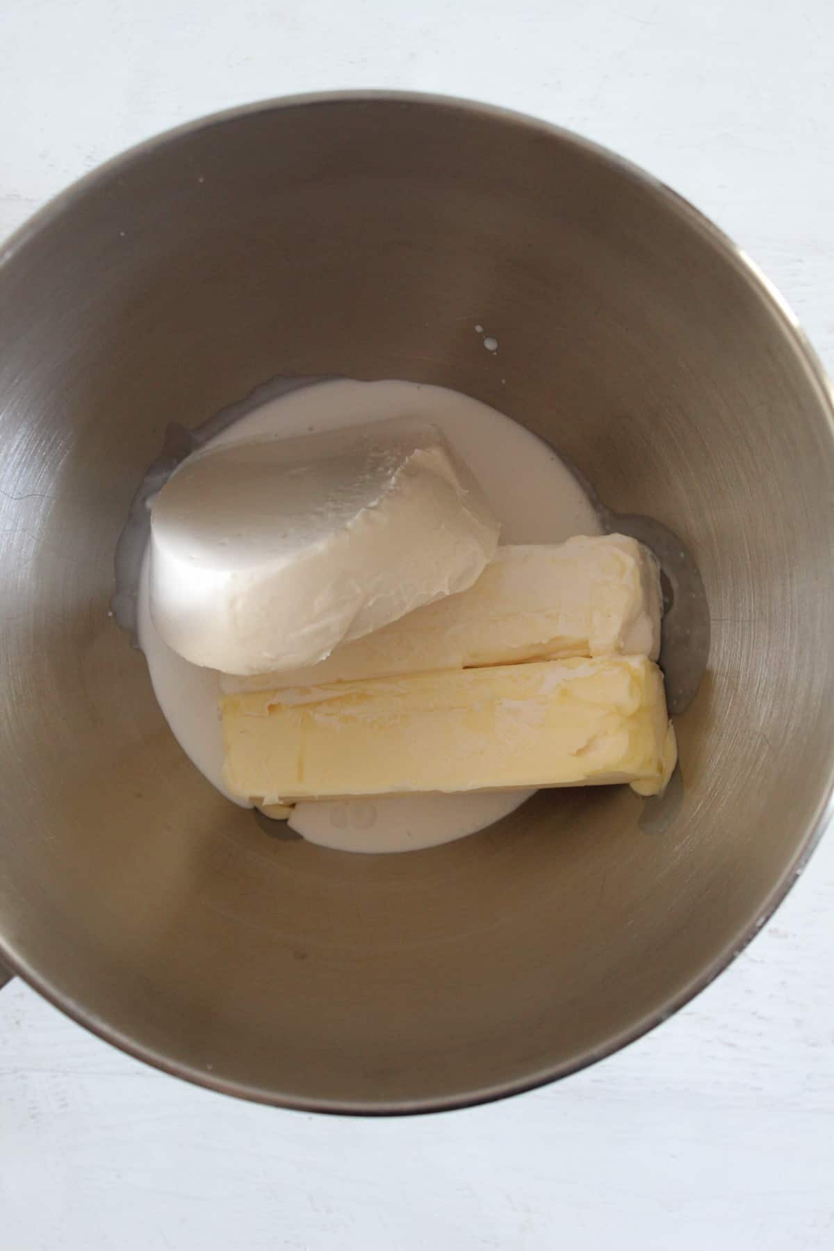 butter, cream cheese and cream in a mixer bowl