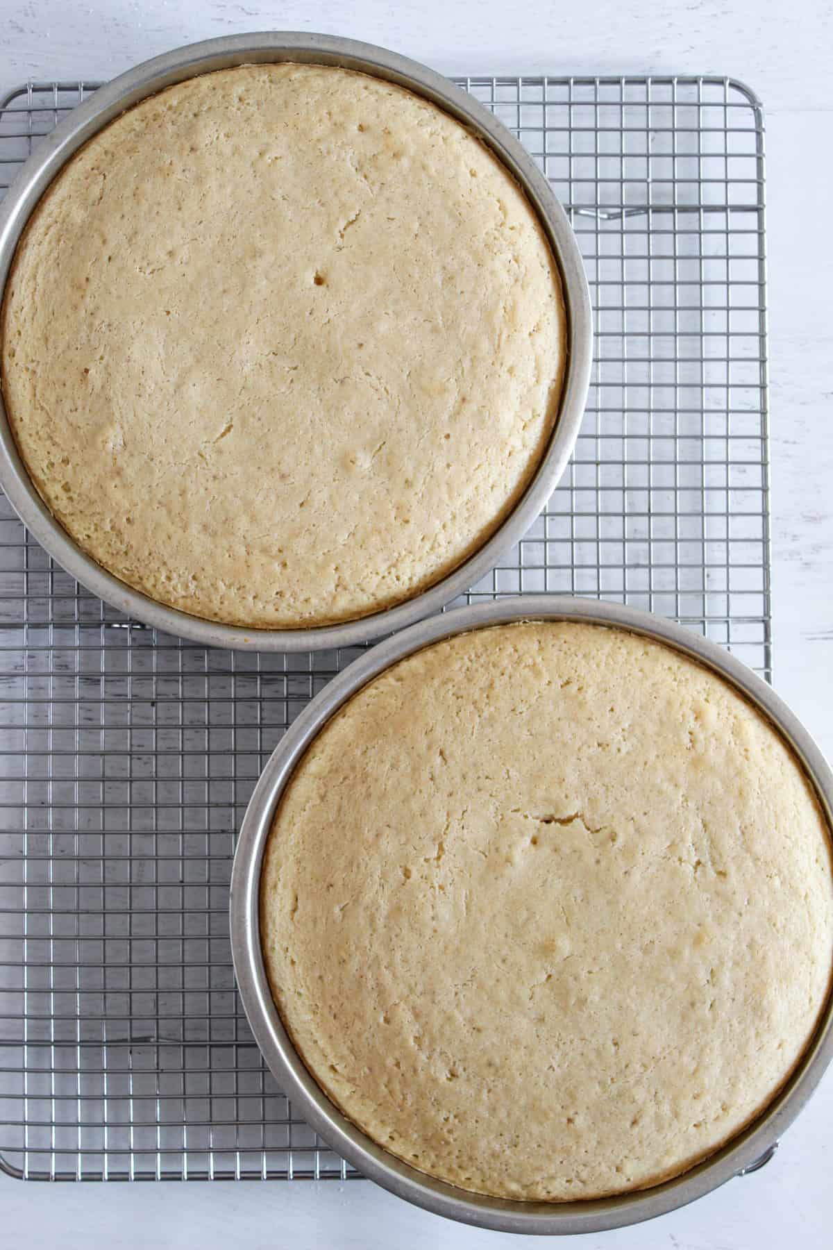 white gluten free cakes cooling on a rack.