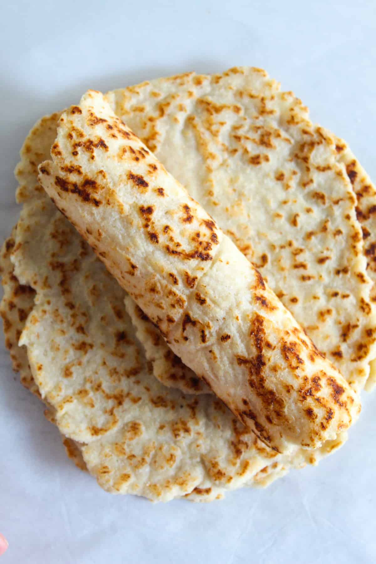almond flour tortillas rolled on a counter.