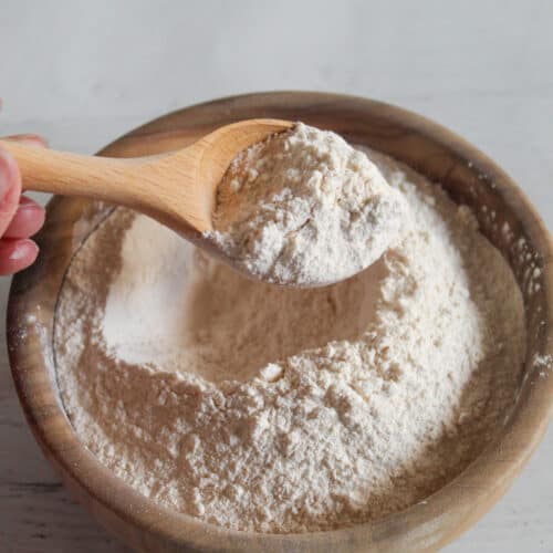 bowl of cassava flour with a wooden spoon