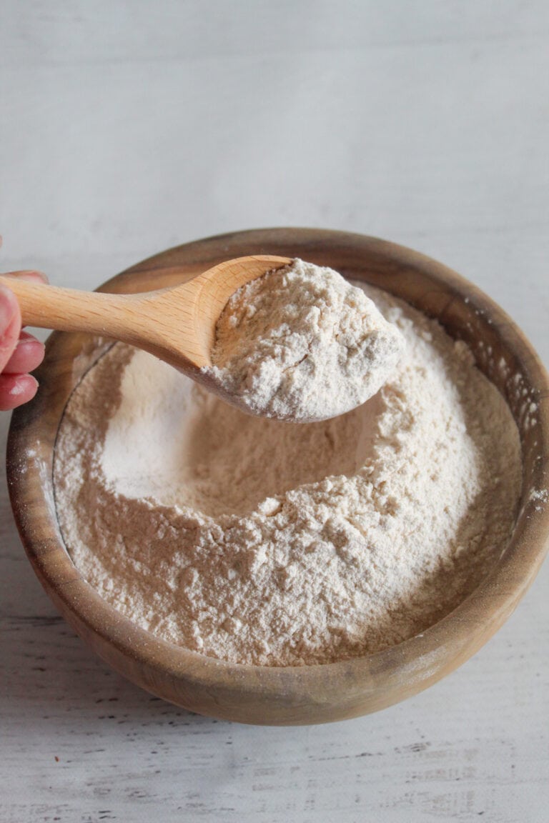 bowl of cassava flour with a wooden spoon