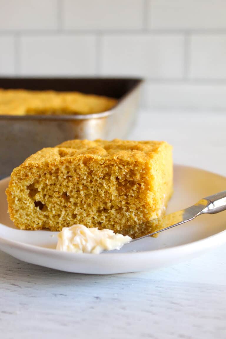 slice of cornbread served on a white plate