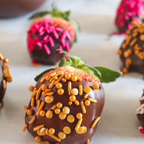 chocolate covered strawberries on a piece of wax paper
