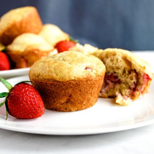 baked gluten free strawberry muffin on a white plate