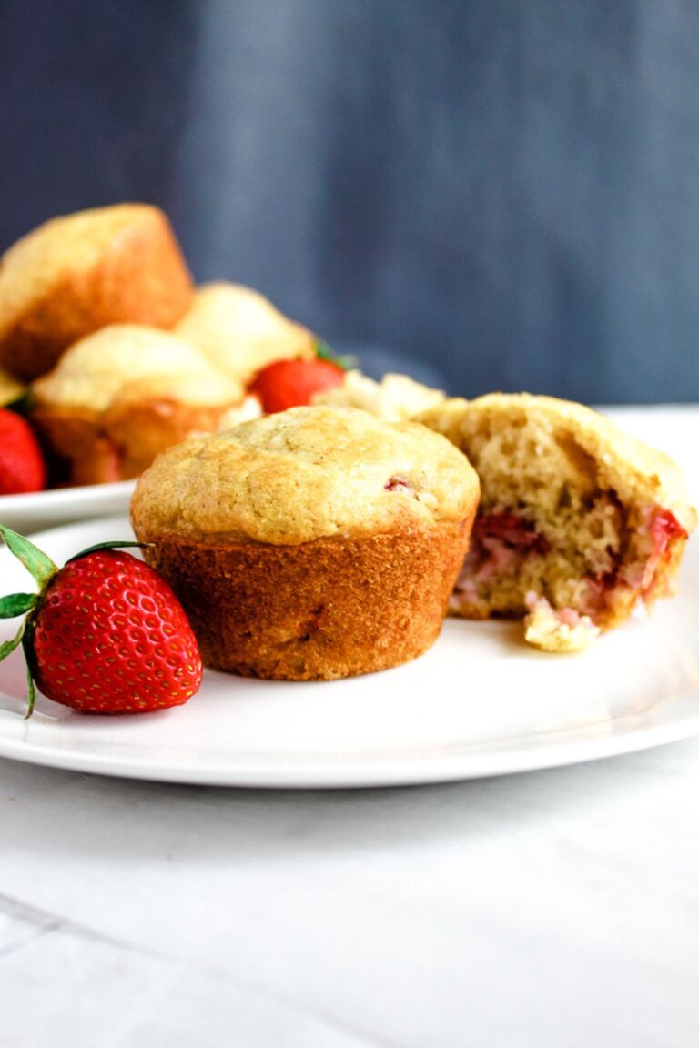 baked gluten free strawberry muffin on a white plate