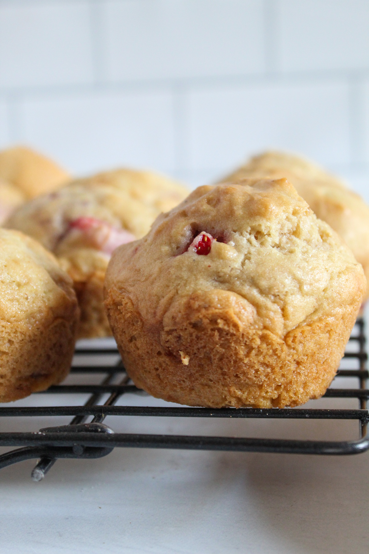 baked gluten free strawberry muffin on a wire rack
