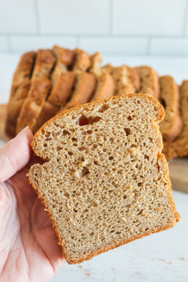 hand holding a slice of bread
