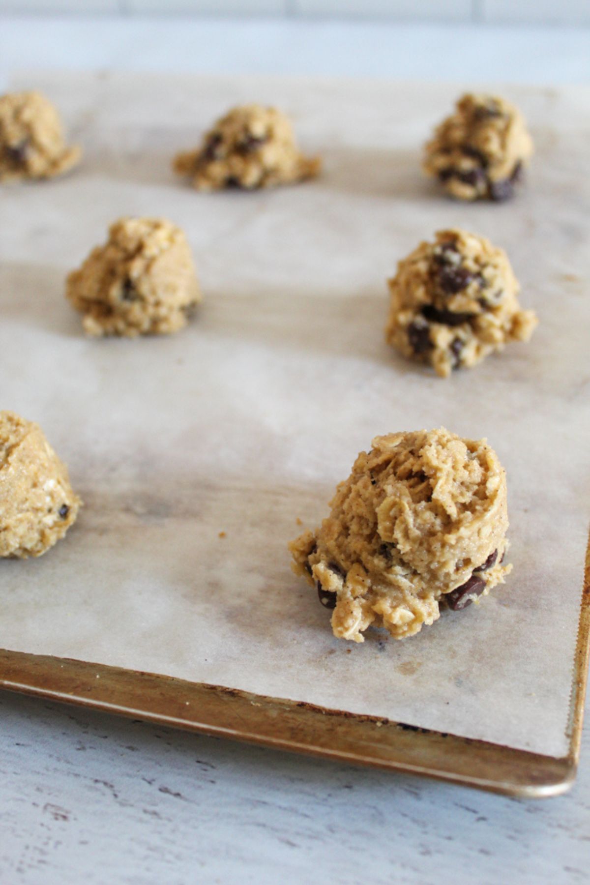 portions of cookie dough on a baking sheet