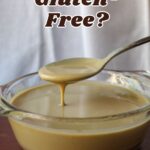 glass bowl of tahini running off a spoon