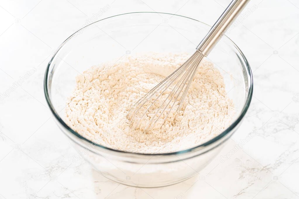 Image of dry ingredients like flour being mixed together in bowl