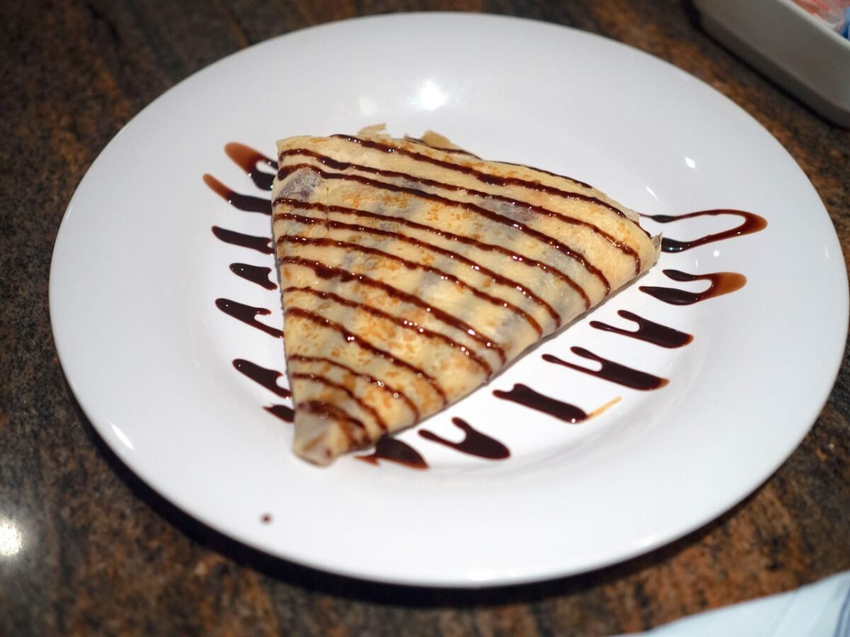 Folded crepe with chocolate sauce on a plate