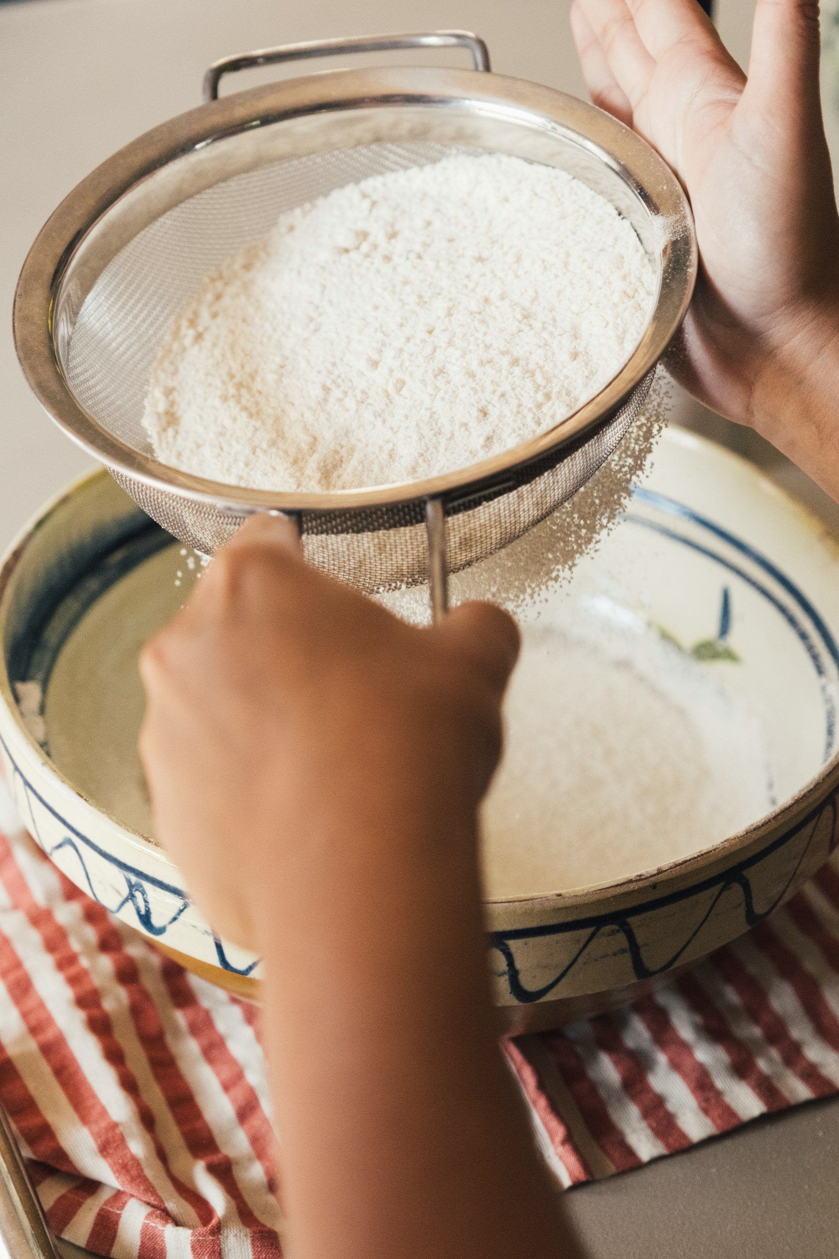 Sifting Gluten free flour into a bowl
