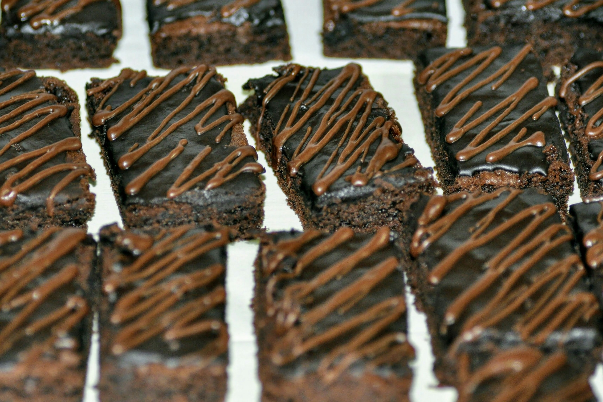 homemade Chocolate Chip Brownies drizzled with melted chocolate.