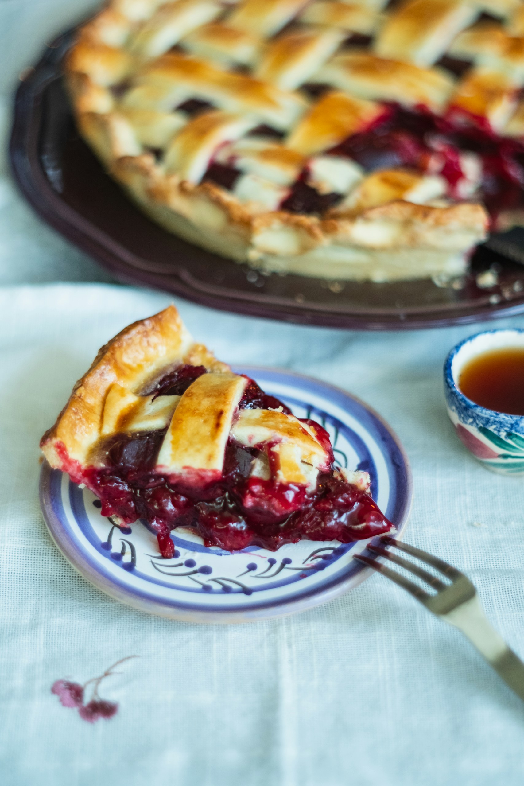 Cherry pie on a white and blue plate