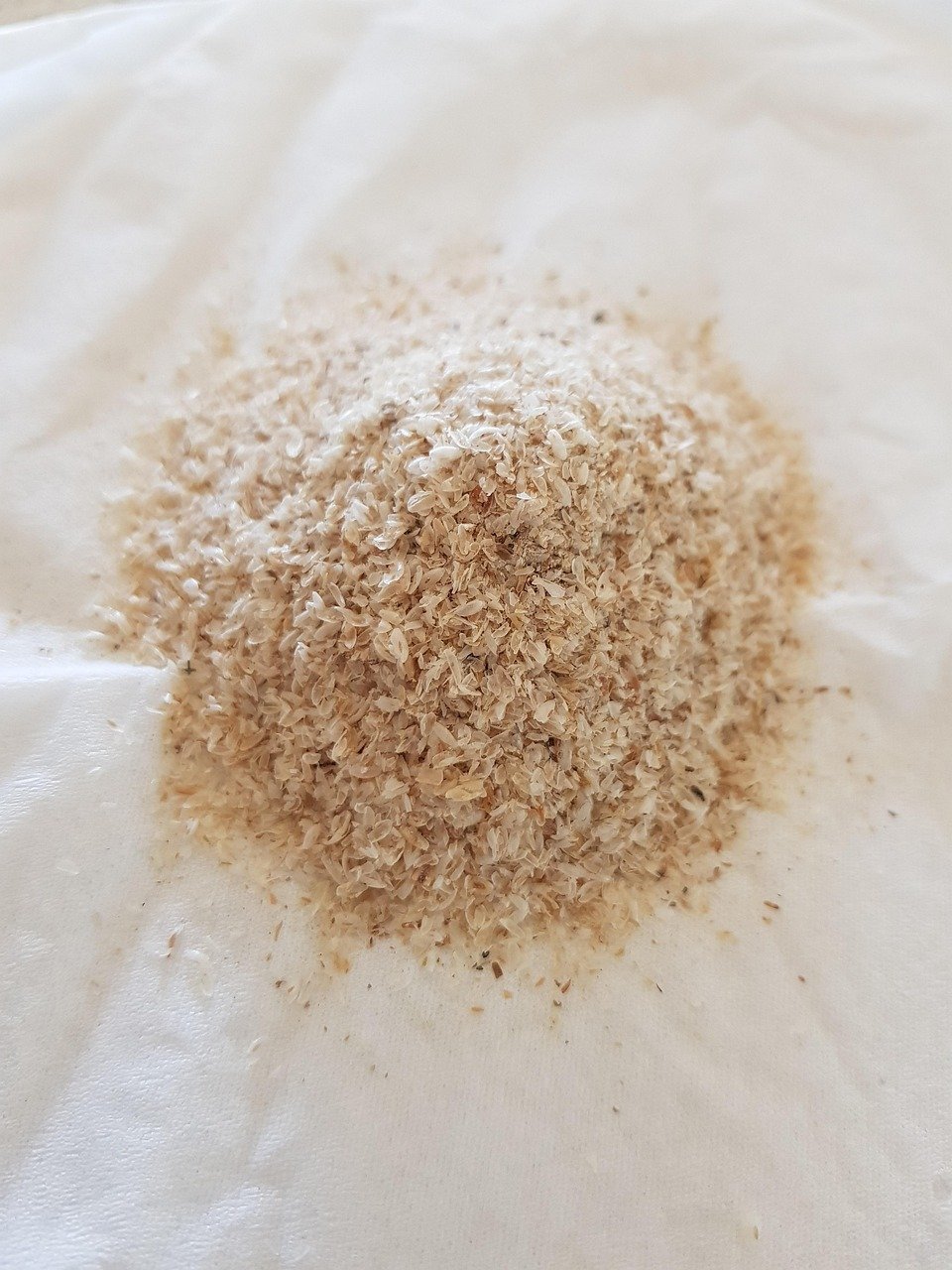 chia seeds vs psyllium husk: psyllium husk on a parchment paper