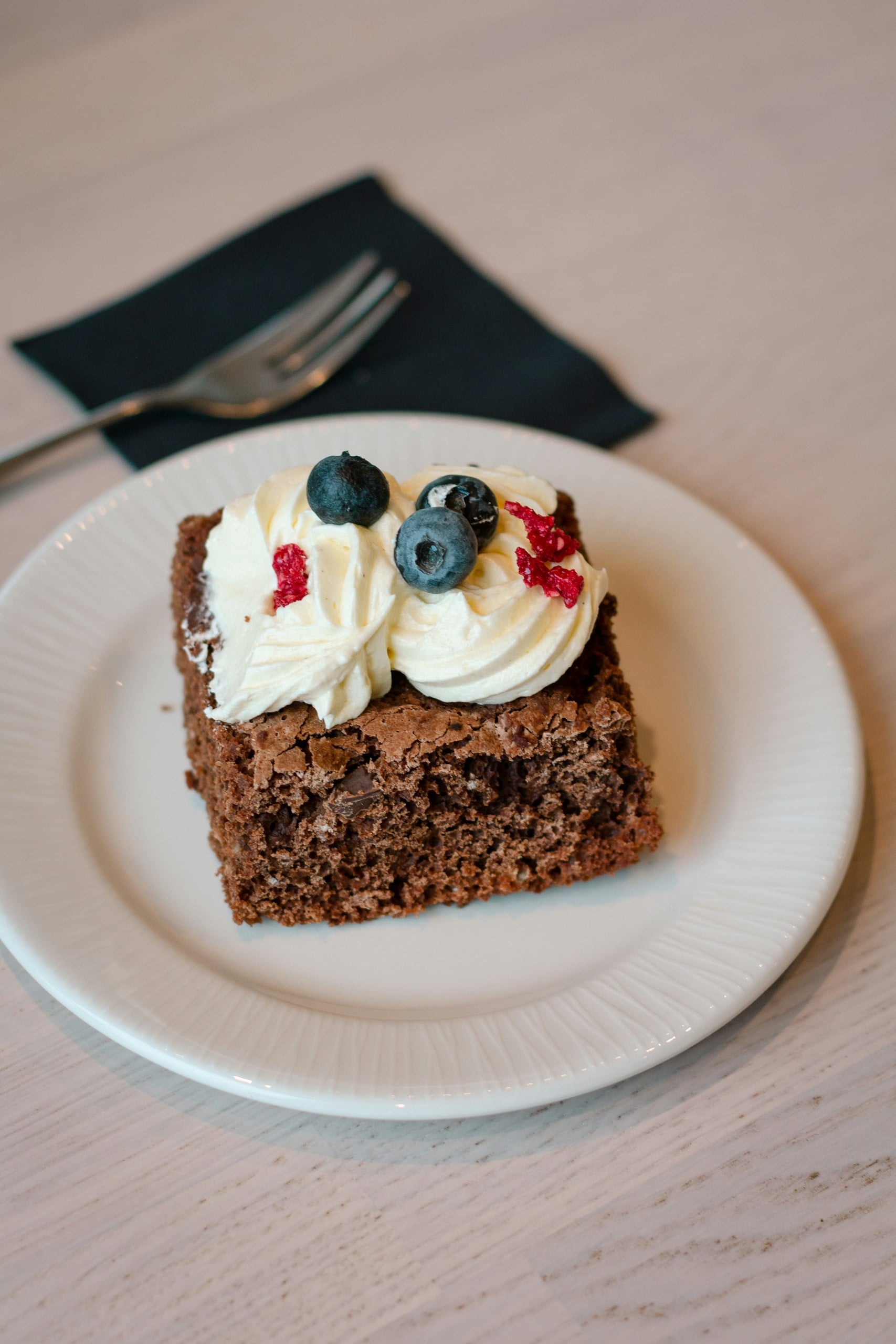 Vegan brownie with whipped cream and berries