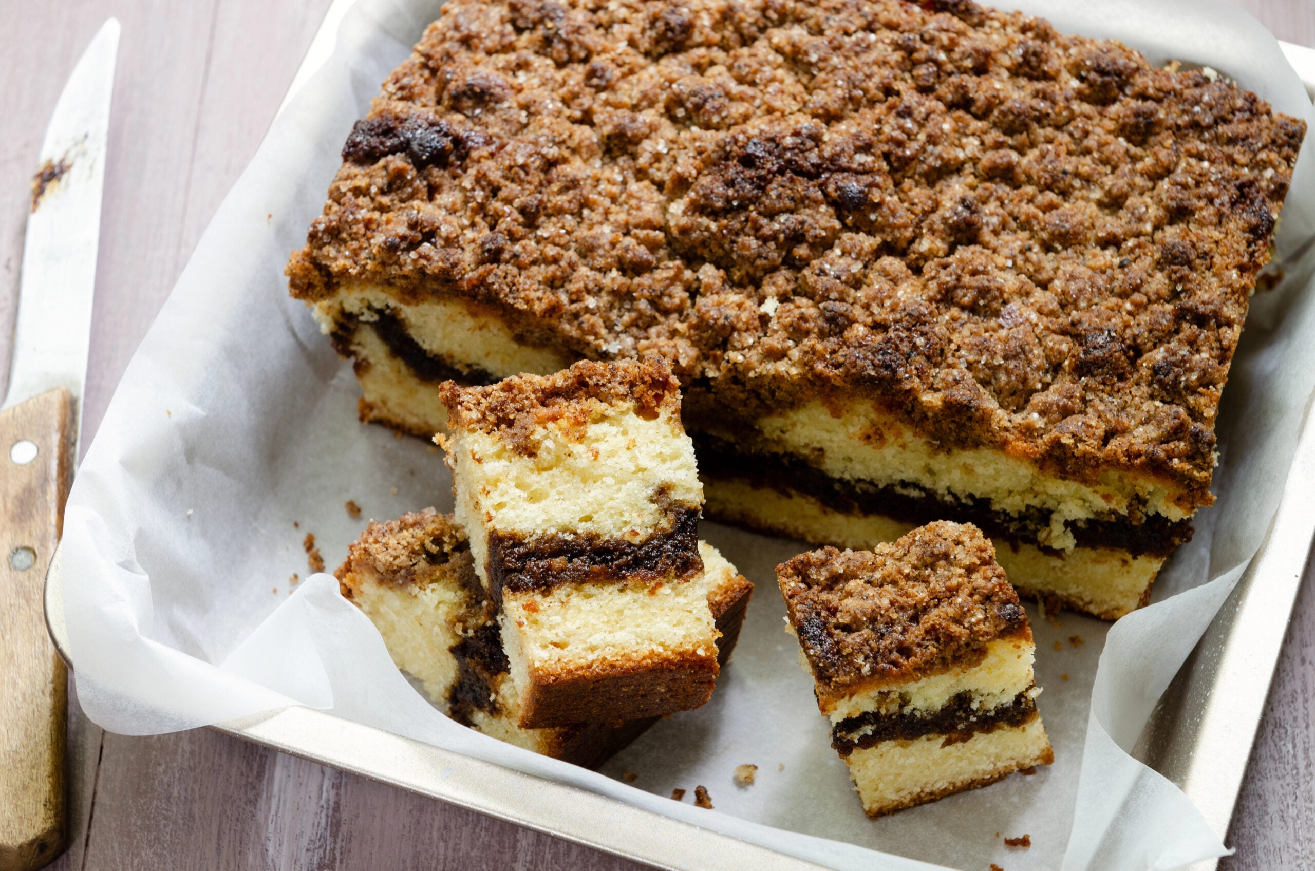 Close-up view of coffee cake has a ribbon of coffee filling and a crisp streusel topping.