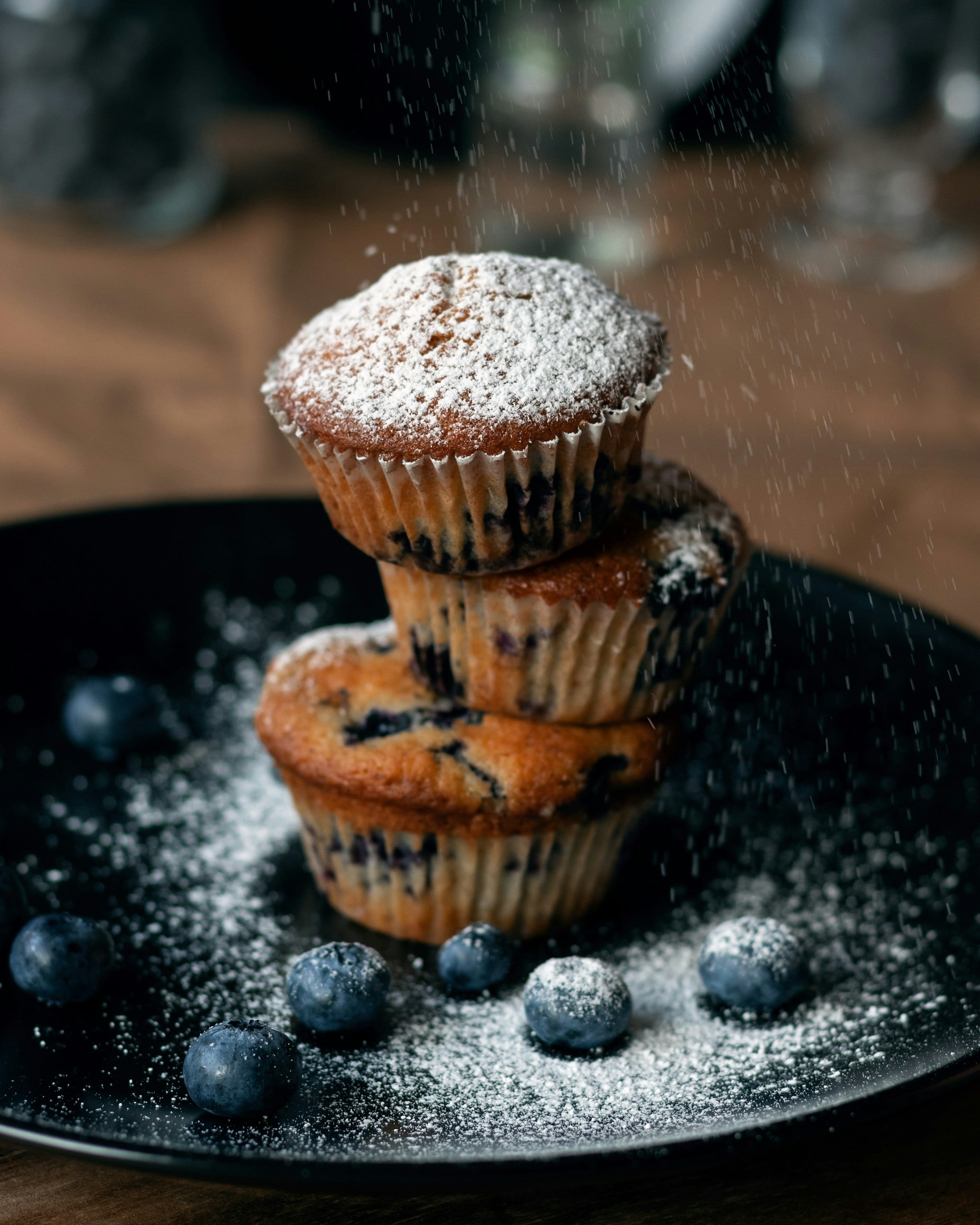 stack of blueberry muffins with powder sugar