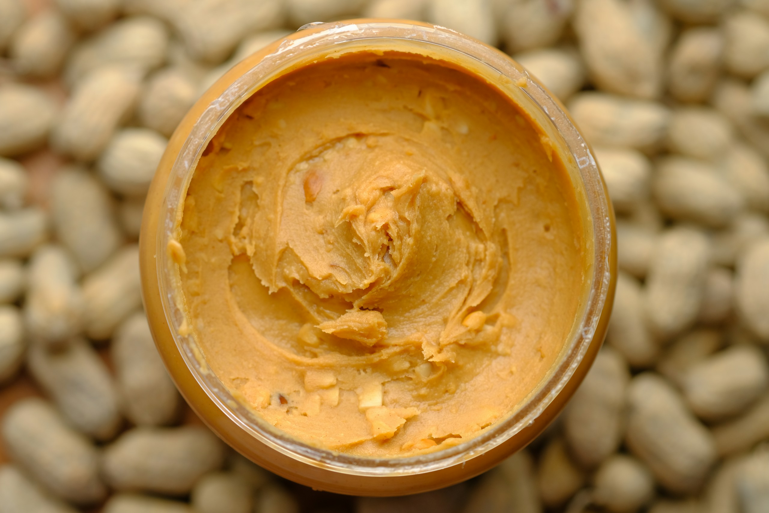 Best Egg Substitutes: top view of peanut butter in a container