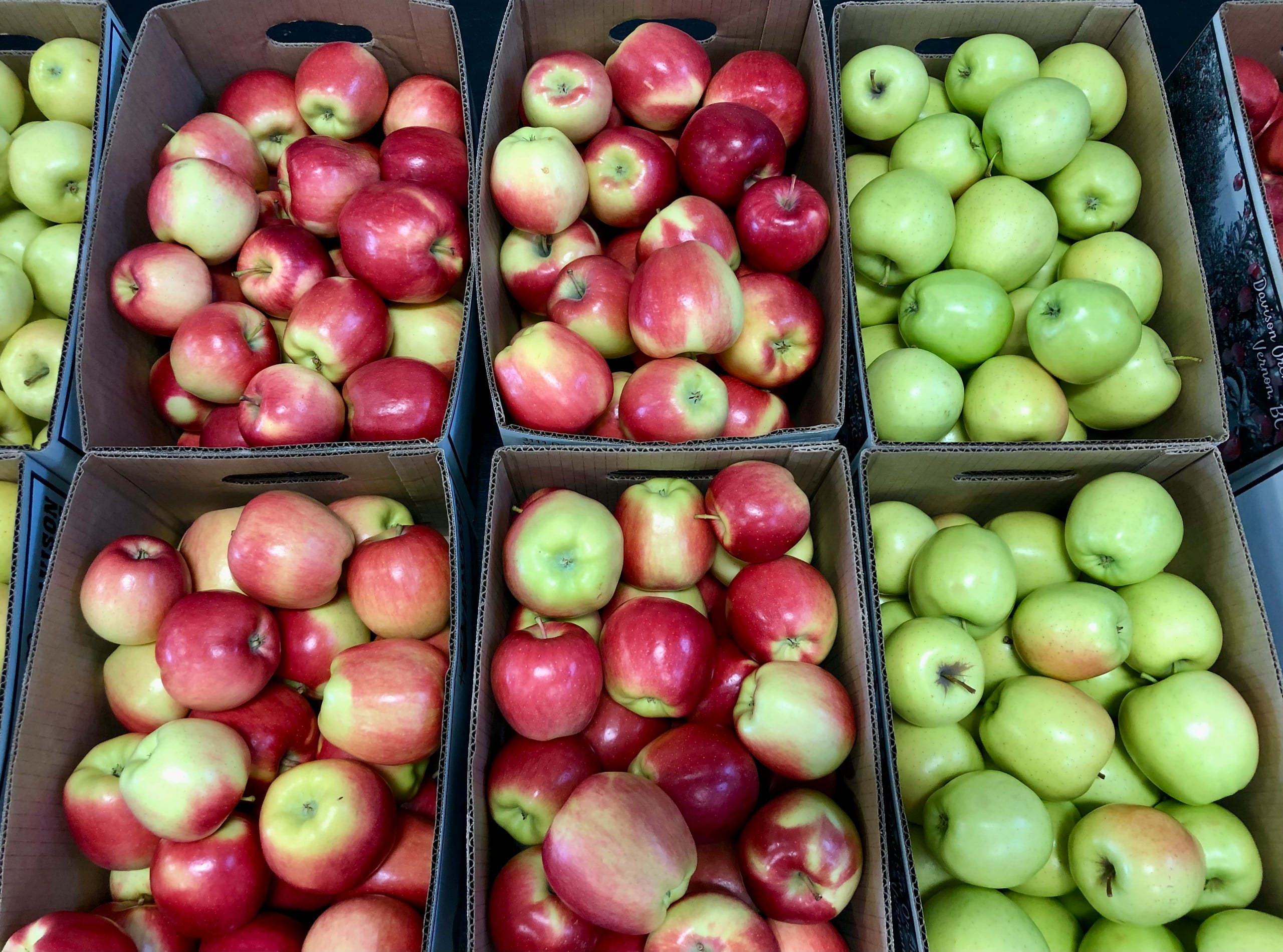 Apples - fresh red and green apples in harvest boxes at farm market