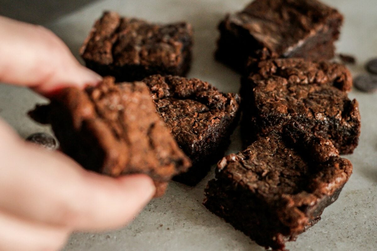 hand and brownie anda chocolate